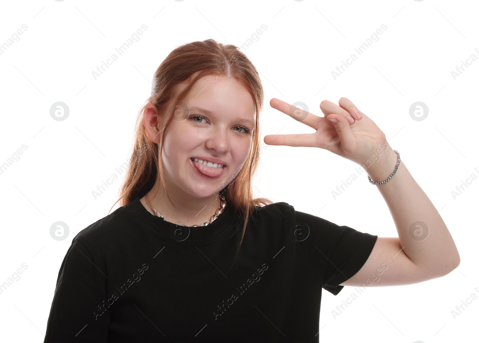 Photo of Teenage girl showing her tongue and v-sign on white background