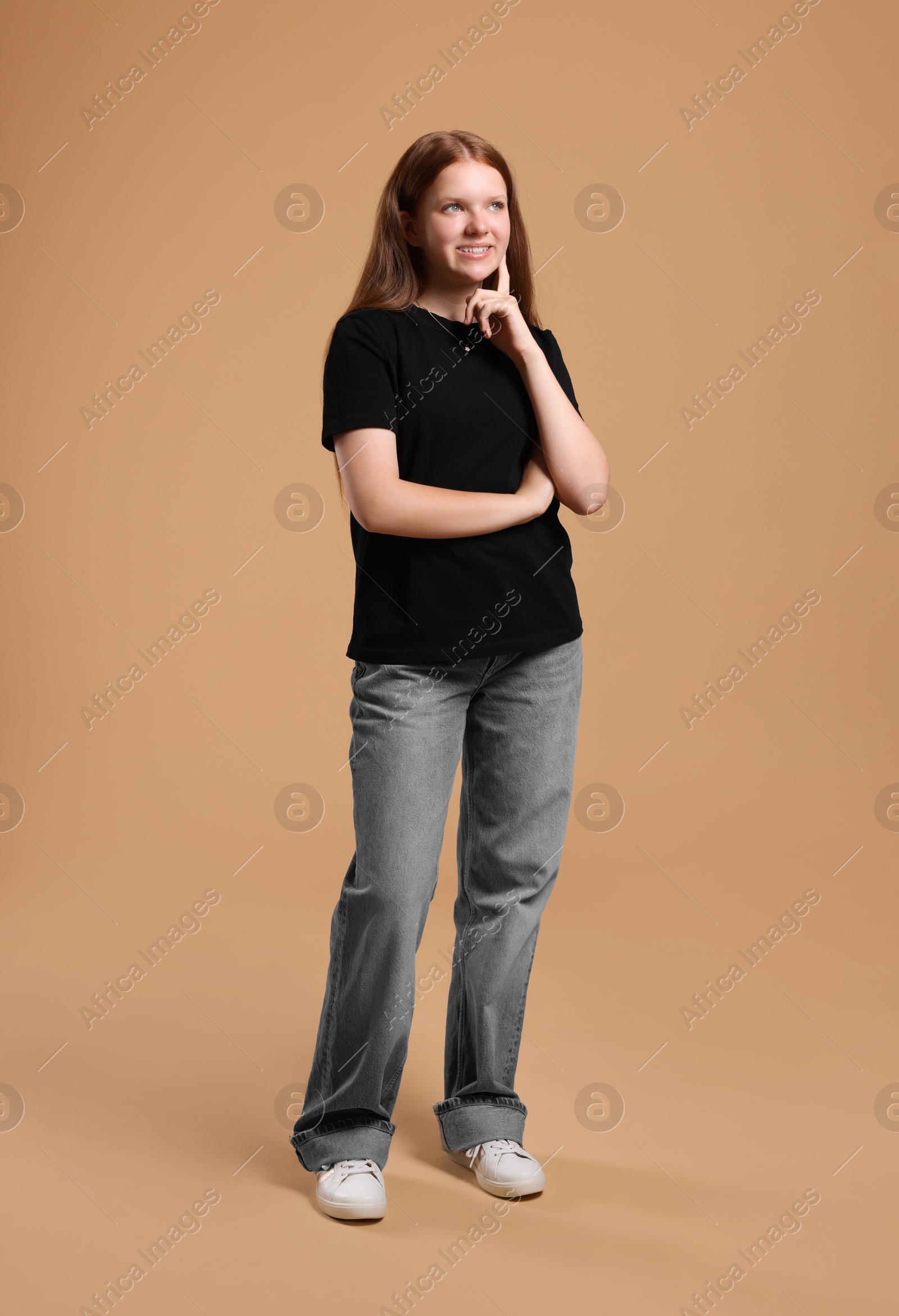 Photo of Full length portrait of teenage girl on beige background