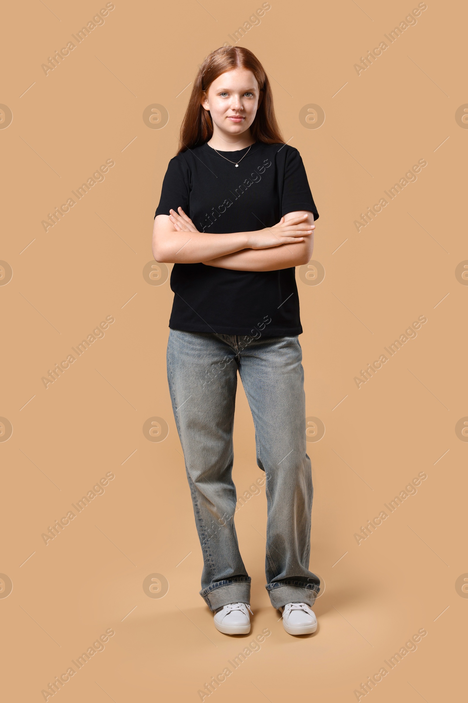 Photo of Full length portrait of teenage girl on beige background