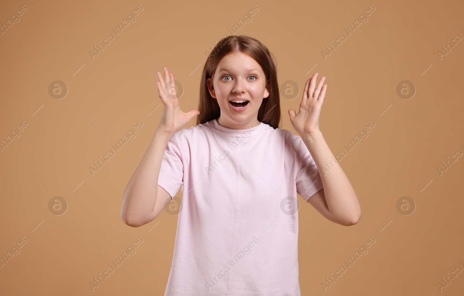 Photo of Portrait of teenage girl on beige background, space for text