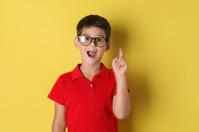 Photo of Portrait of cute little boy on yellow background