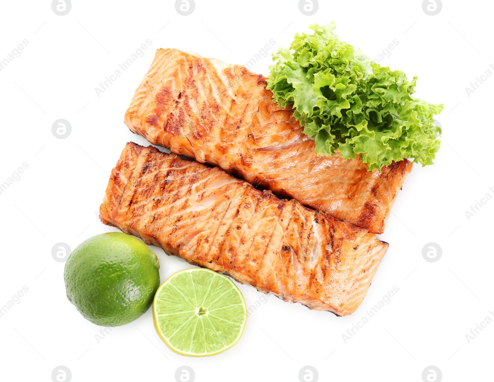 Photo of Delicious grilled salmon fillets with lime and lettuce isolated on white, top view