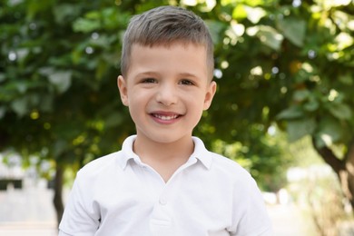 Photo of Portrait of little boy outdoors. Cute child