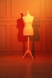 Photo of One mannequin near wall in neon lights