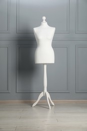 Photo of One mannequin near grey wall. Fashion designer`s equipment