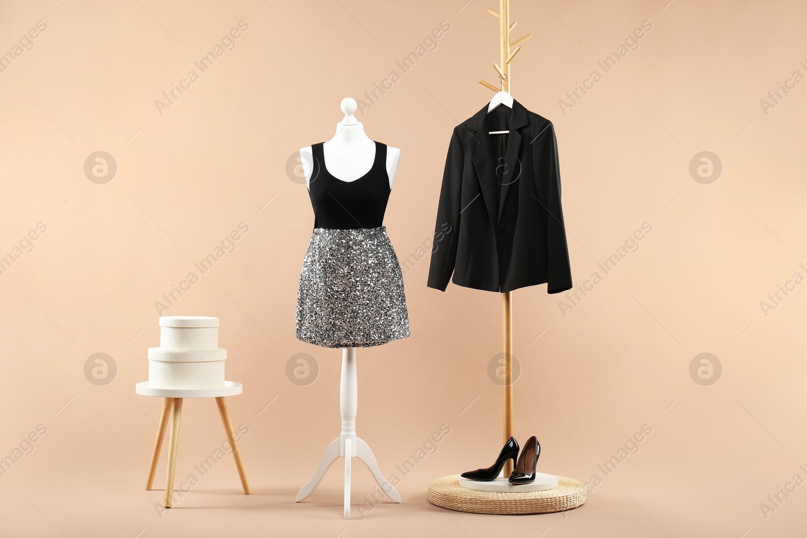 Photo of Mannequin with stylish dress, jacket and shoes on beige background