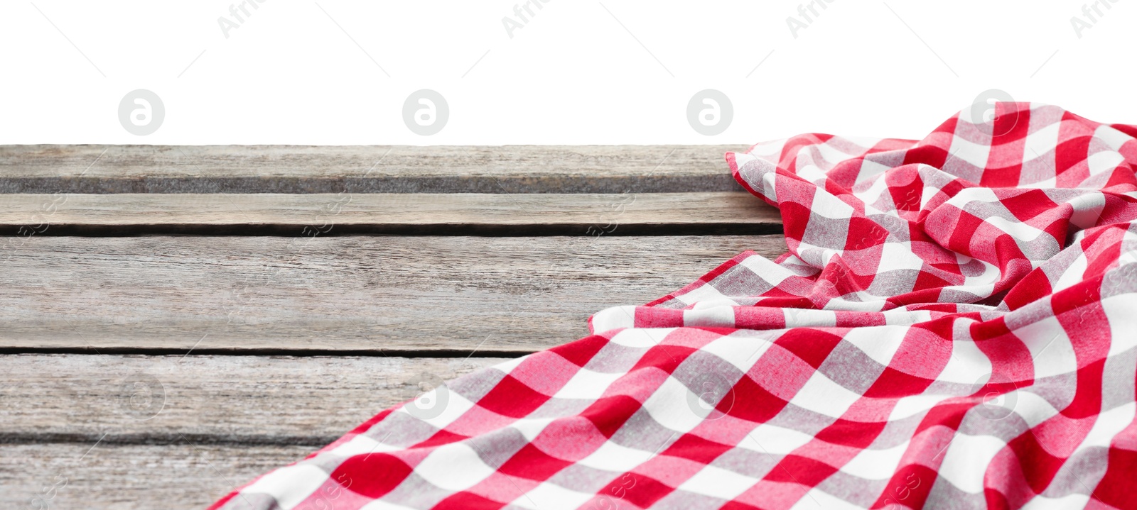 Photo of Crumpled tablecloth with checkered pattern on wooden table against white background