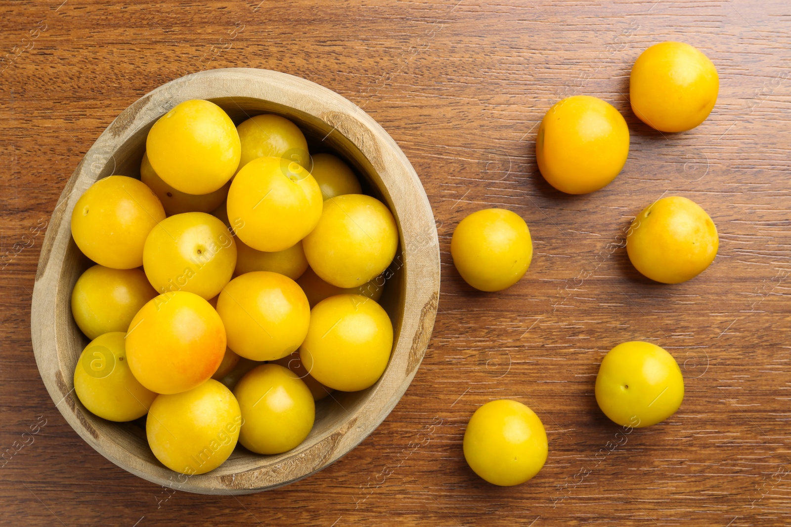 Photo of Fresh plums on wooden table, flat lay