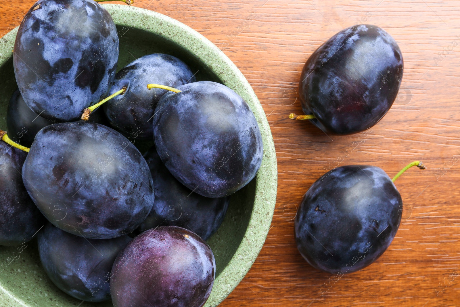 Photo of Fresh plums on wooden table, flat lay