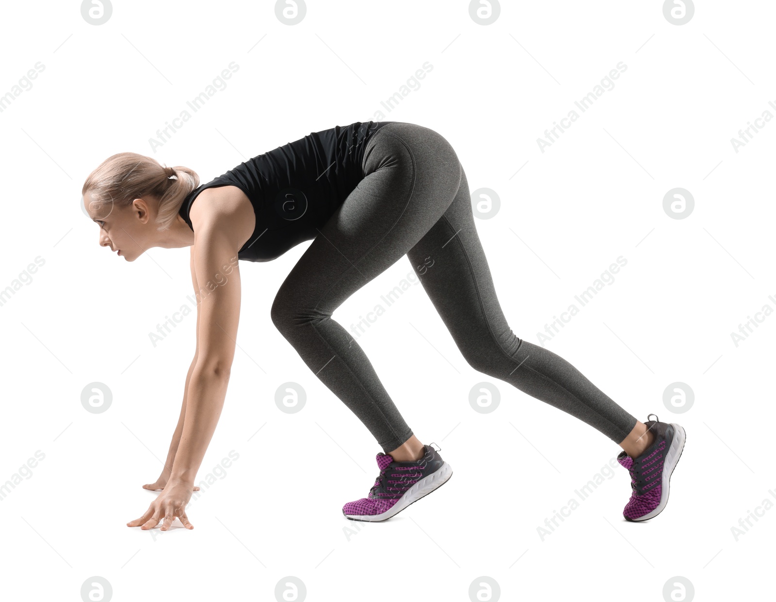 Photo of Runner in starting position on white background