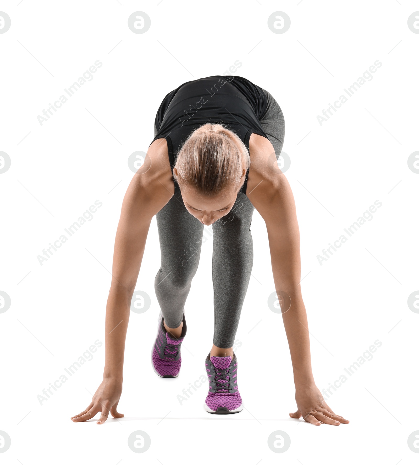 Photo of Runner in starting position on white background