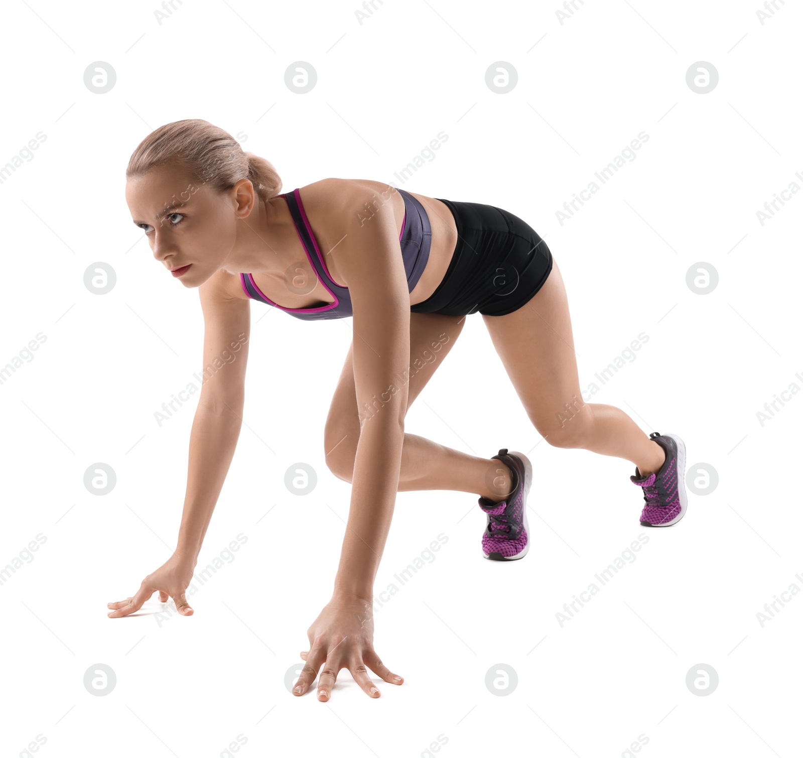 Photo of Runner in starting position on white background