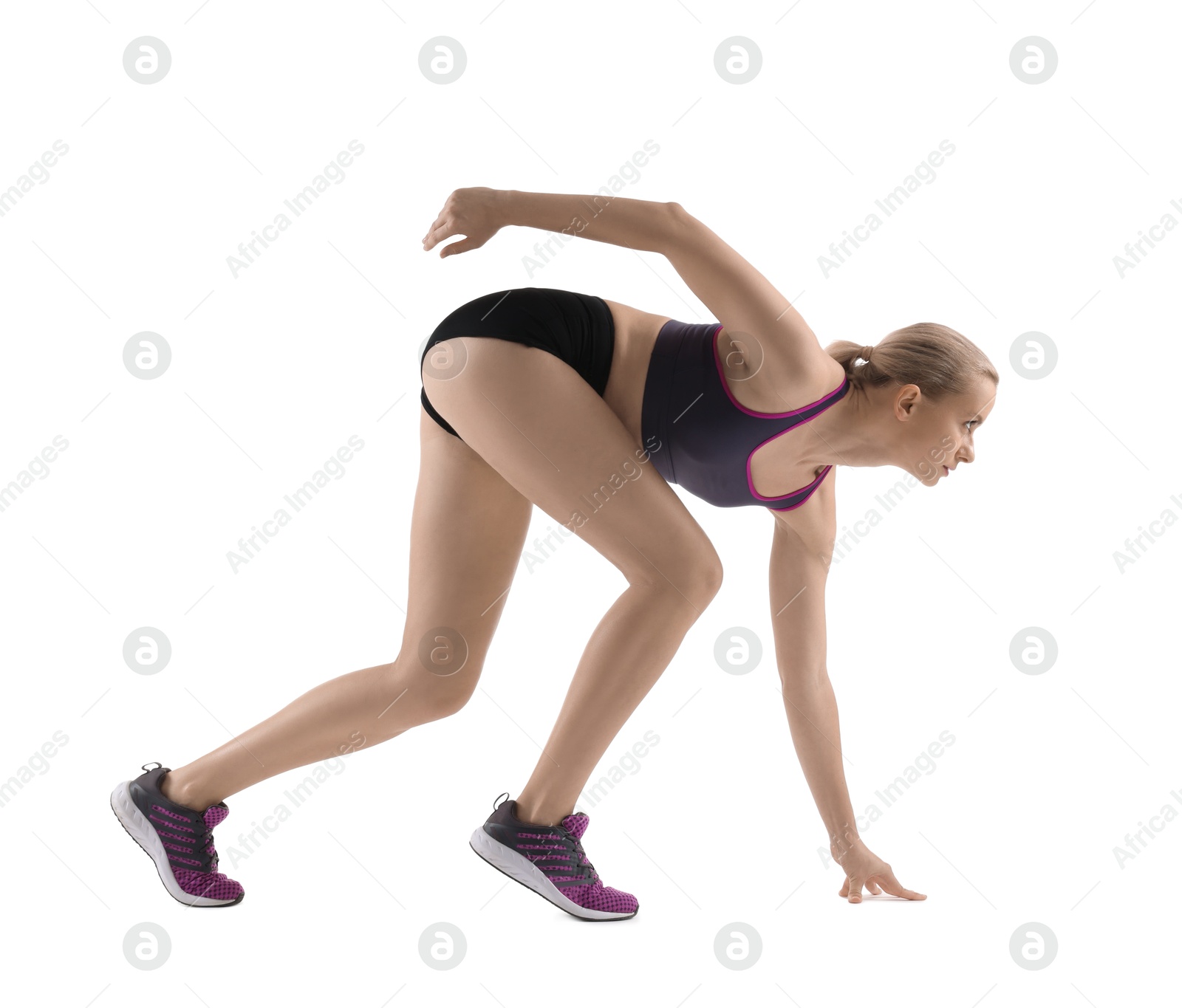 Photo of Runner in starting position on white background