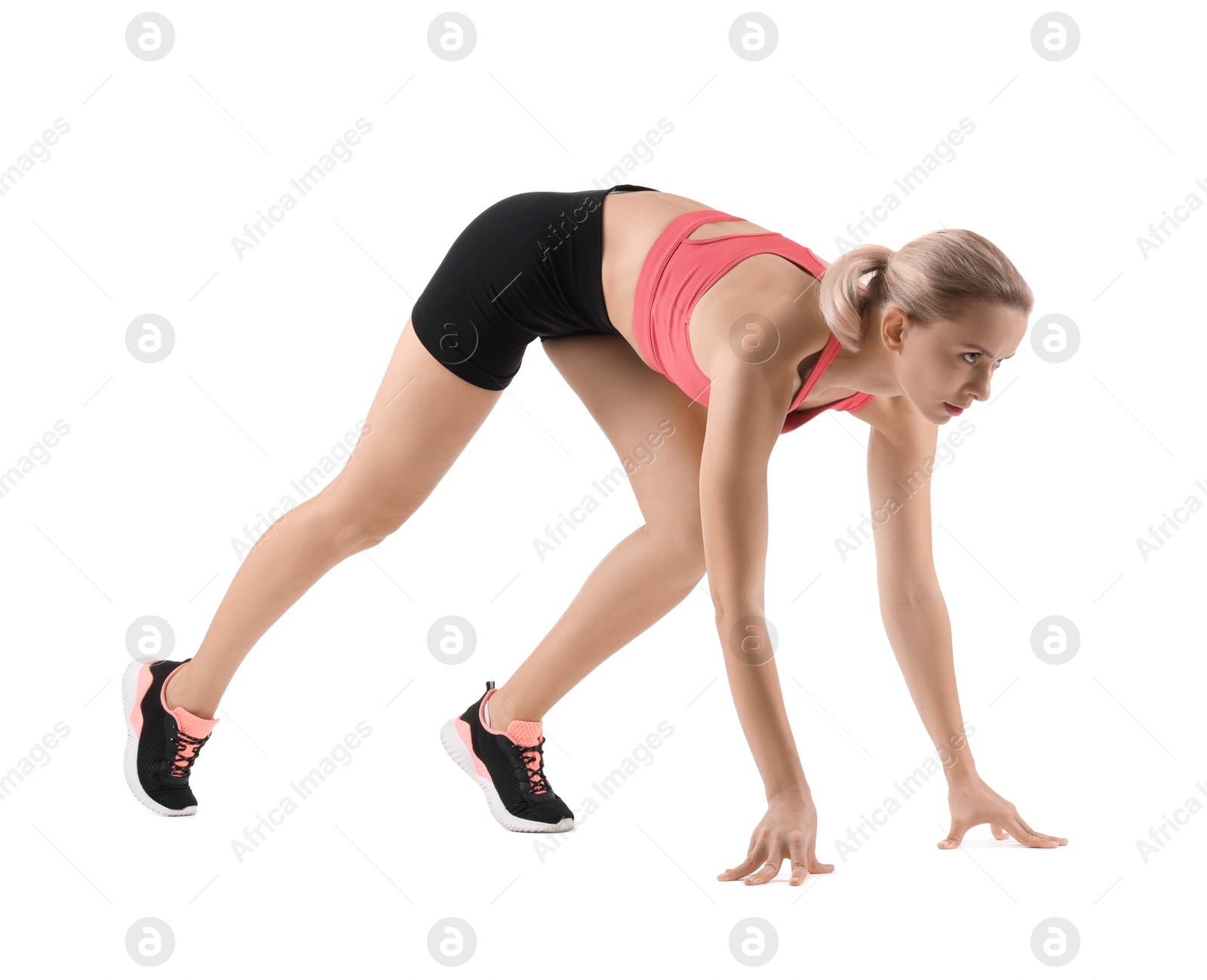 Photo of Runner in starting position on white background