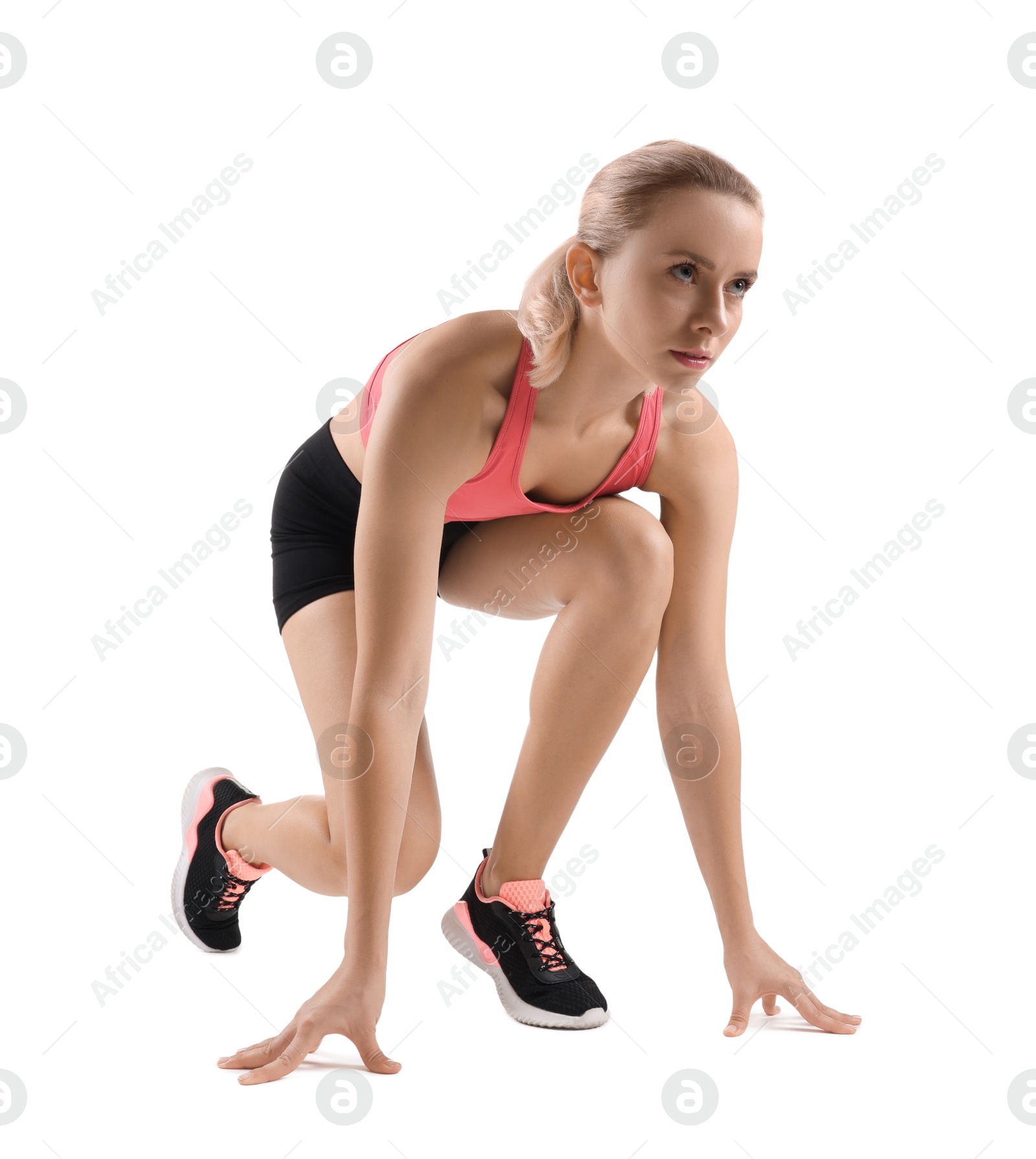 Photo of Runner in starting position on white background