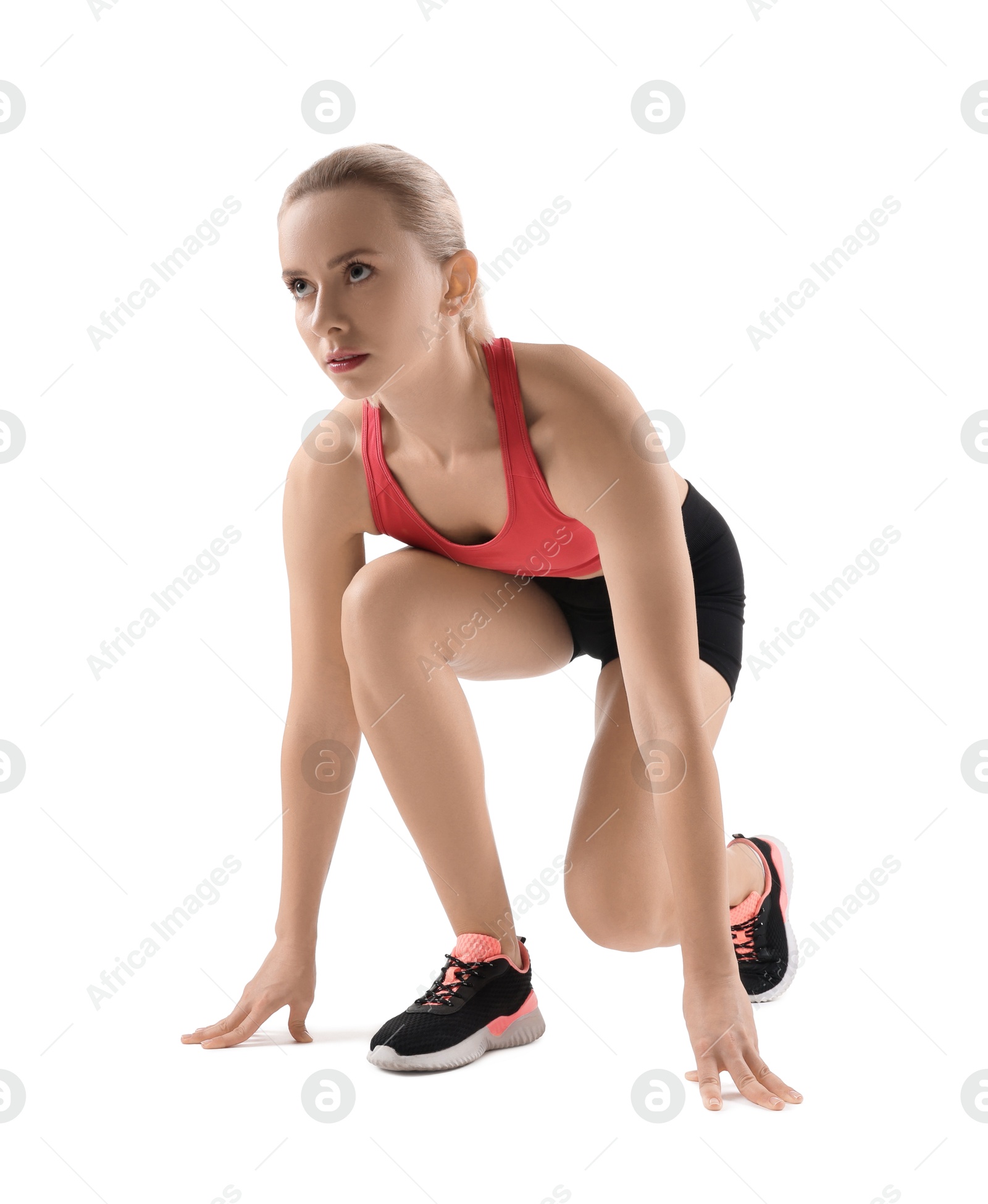 Photo of Runner in starting position on white background