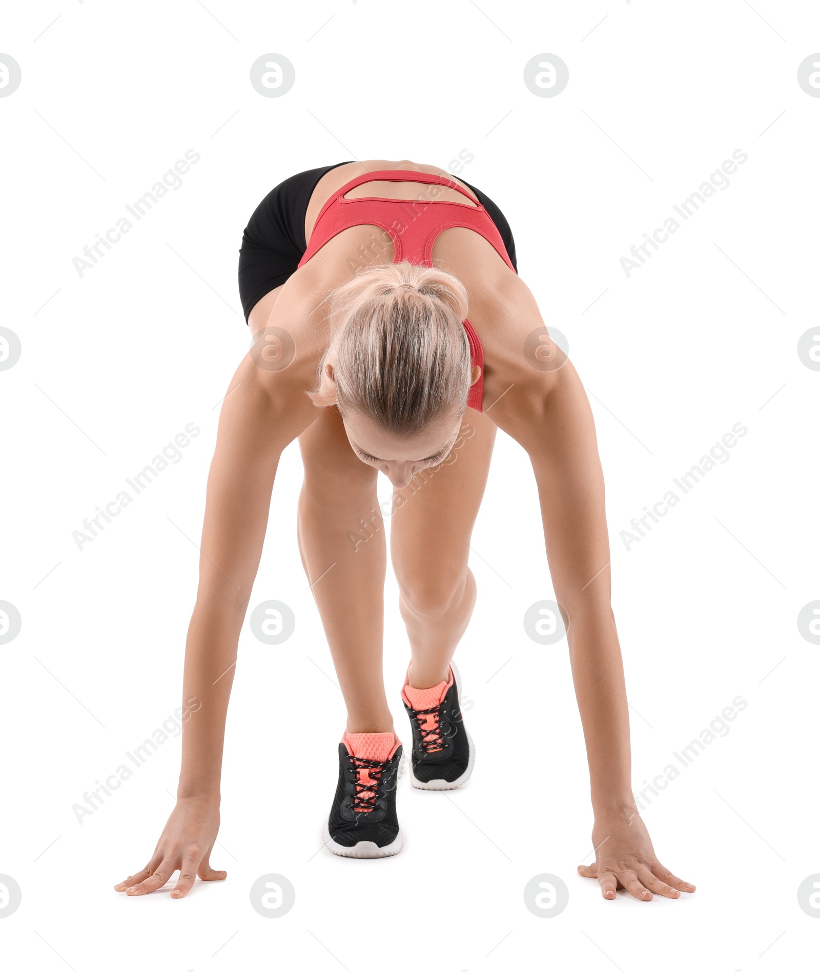 Photo of Runner in starting position on white background