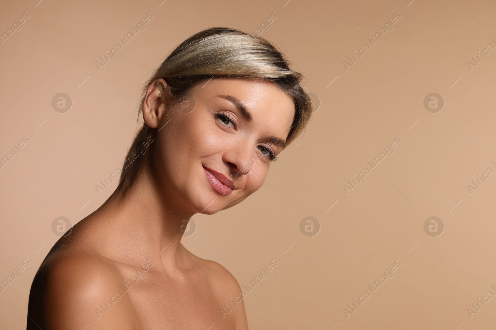 Photo of Cosmetology. Beautiful woman with perfect skin on beige background, space for text