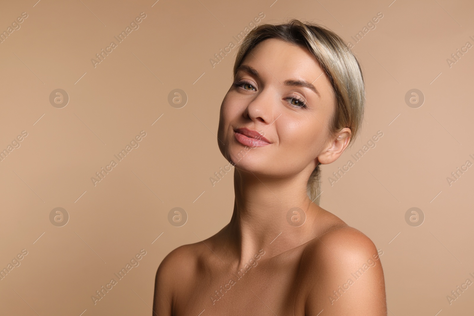 Photo of Cosmetology. Beautiful woman with perfect skin on beige background