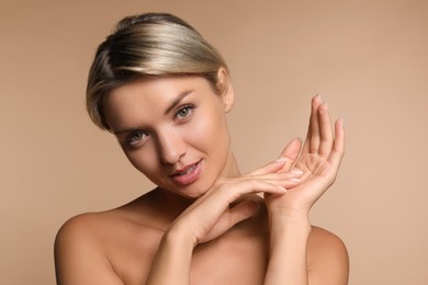 Photo of Cosmetology. Beautiful woman with perfect skin on beige background