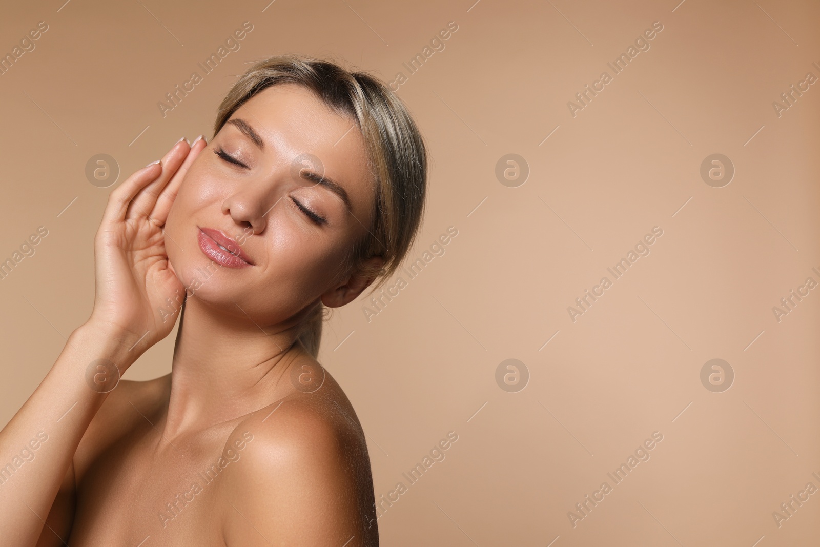 Photo of Cosmetology. Beautiful woman with perfect skin on beige background, space for text