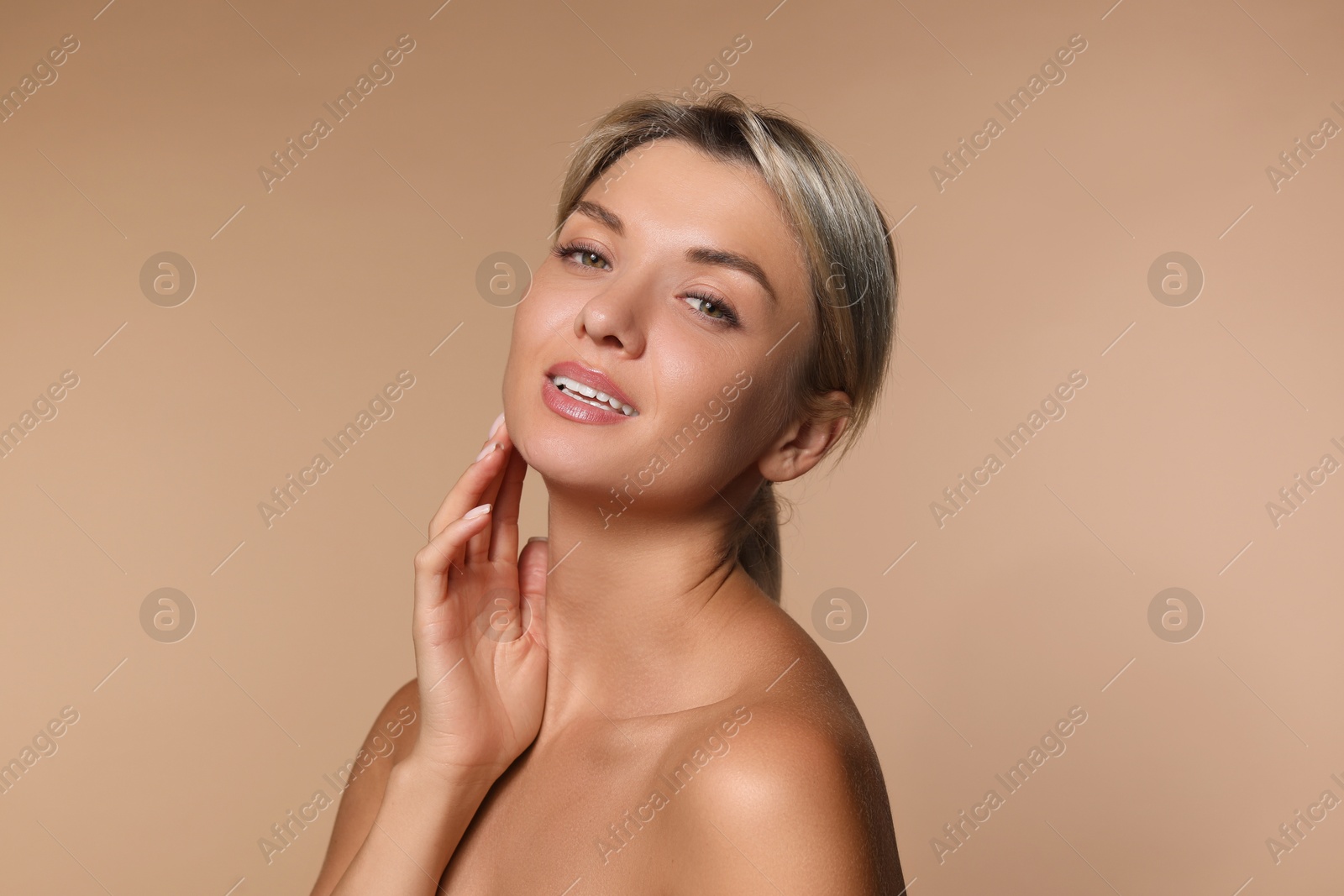 Photo of Cosmetology. Beautiful woman with perfect skin on beige background