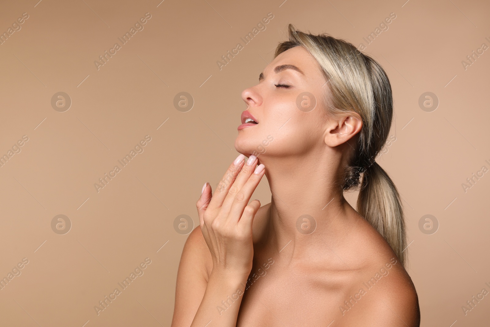 Photo of Cosmetology. Beautiful woman with perfect skin on beige background, space for text