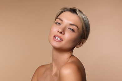 Cosmetology. Beautiful woman with perfect skin on beige background