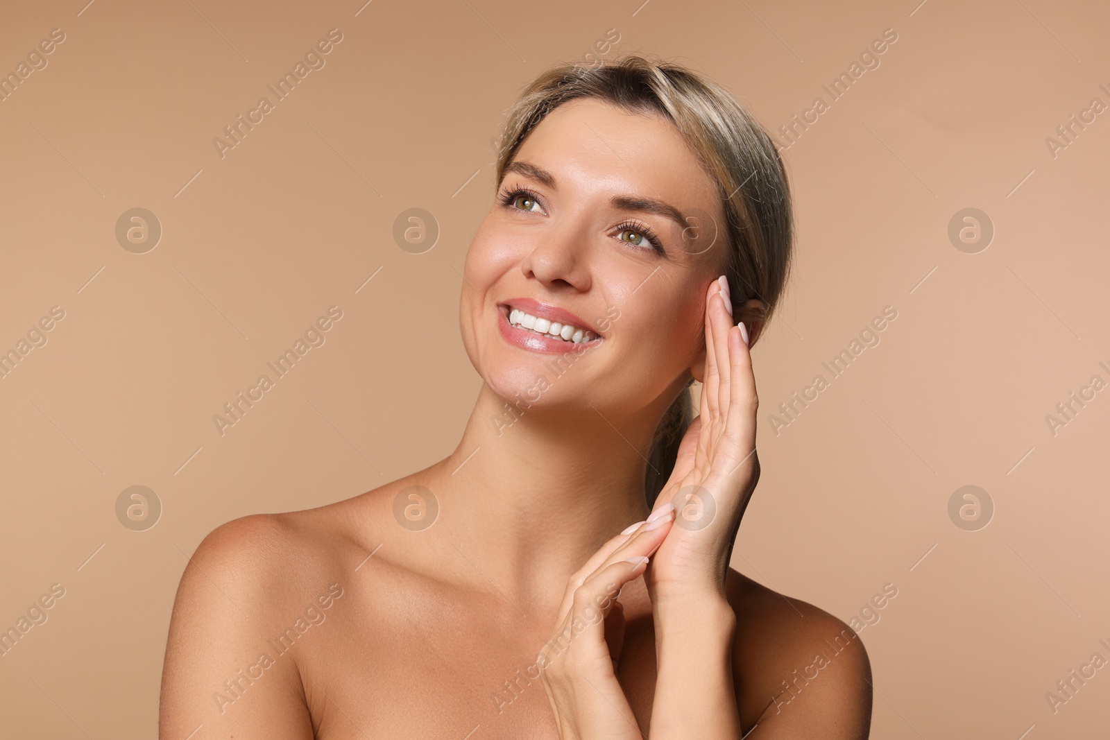 Photo of Cosmetology. Beautiful woman with perfect skin on beige background