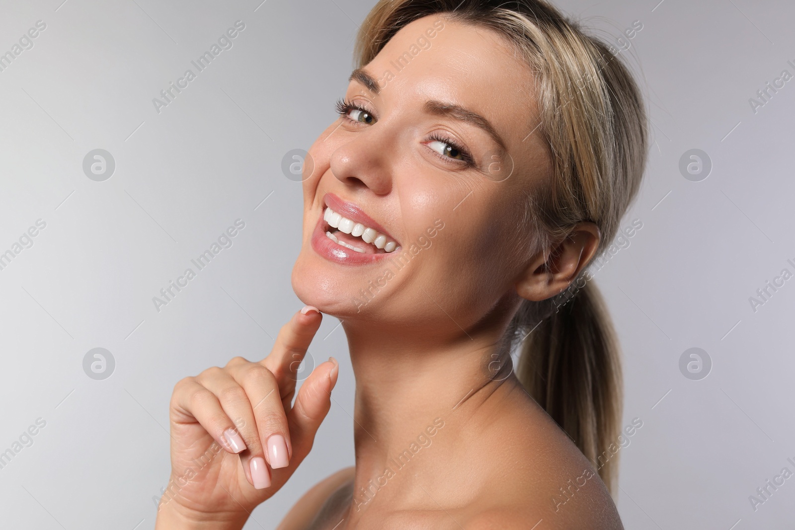 Photo of Cosmetology. Beautiful woman with perfect skin on grey background