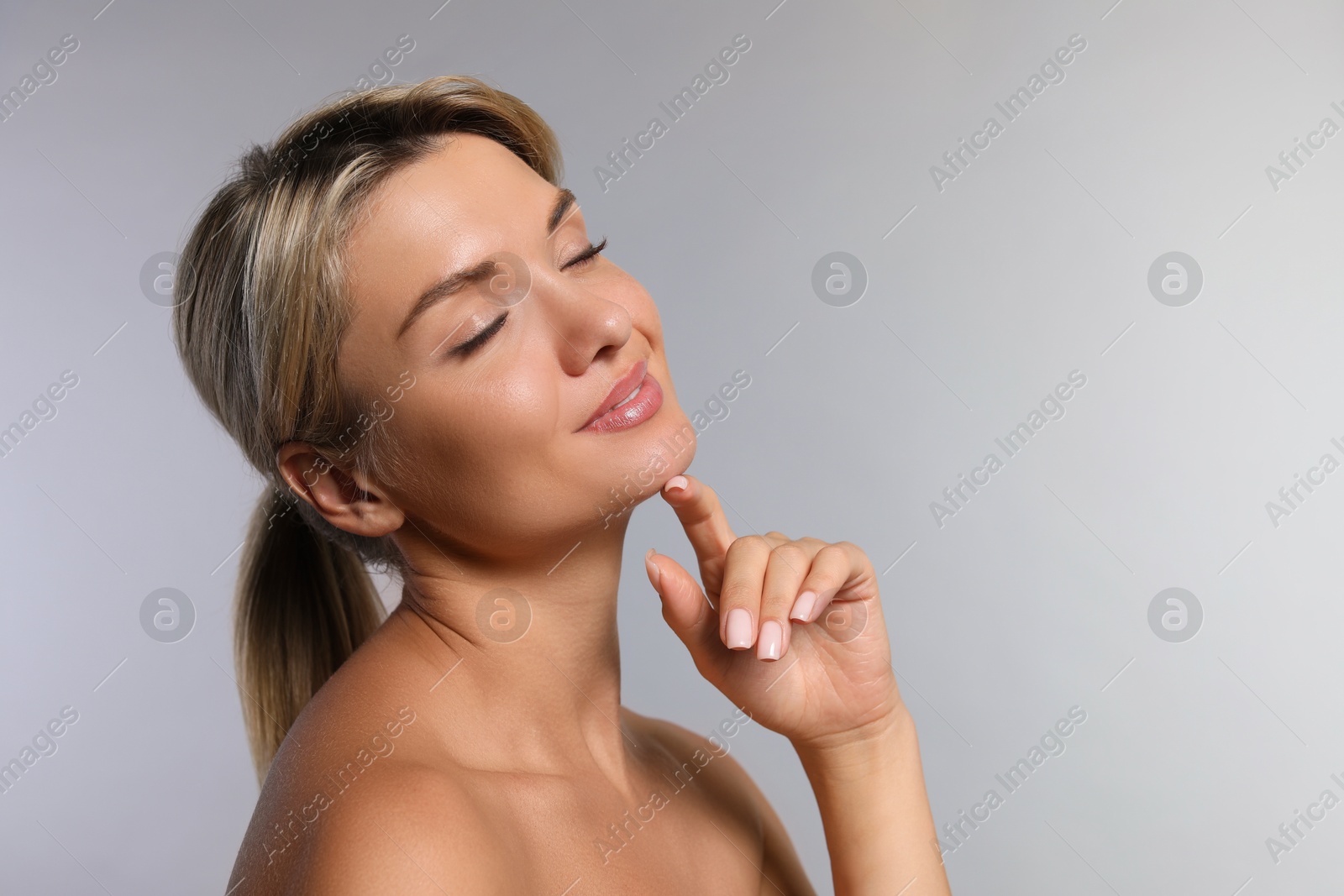 Photo of Cosmetology. Beautiful woman with perfect skin on grey background