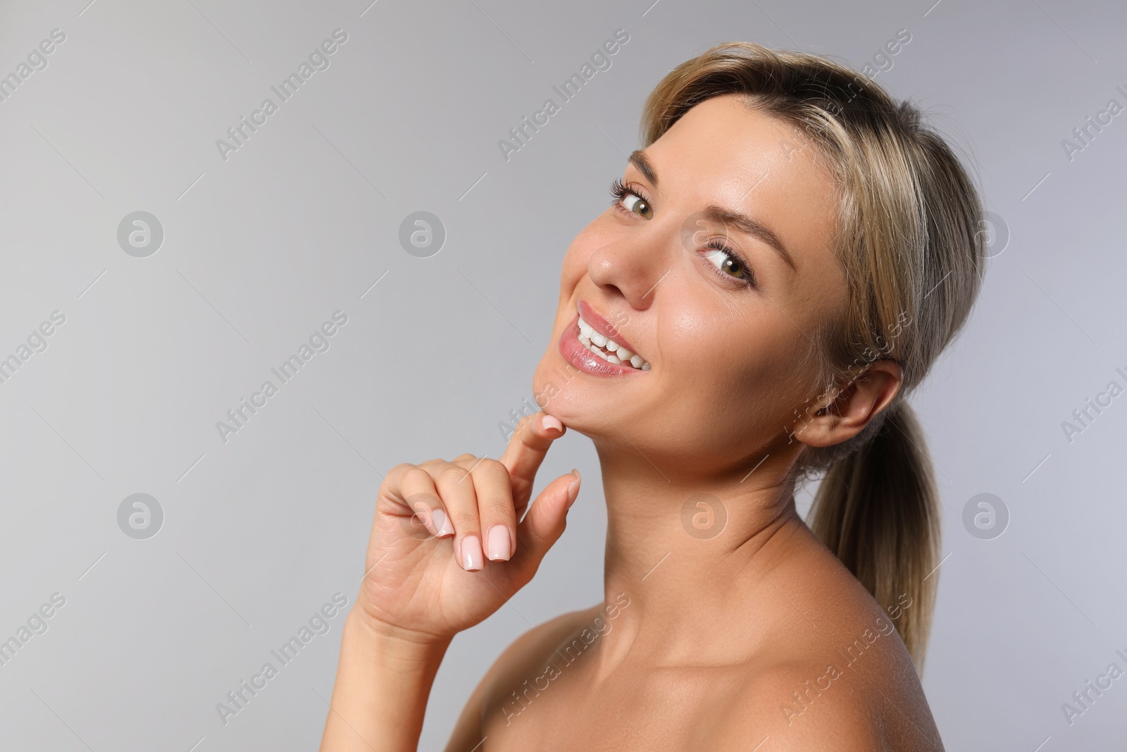 Photo of Cosmetology. Beautiful woman with perfect skin on grey background