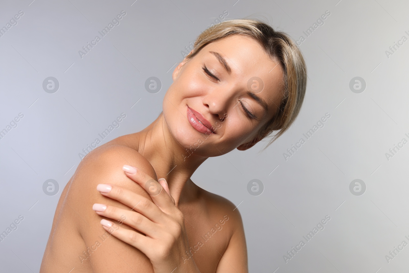 Photo of Cosmetology. Beautiful woman with perfect skin on grey background