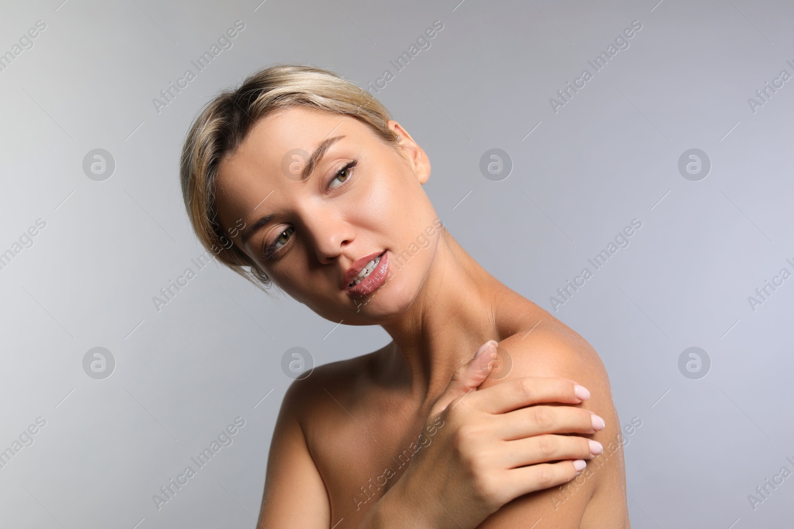 Photo of Cosmetology. Beautiful woman with perfect skin on grey background