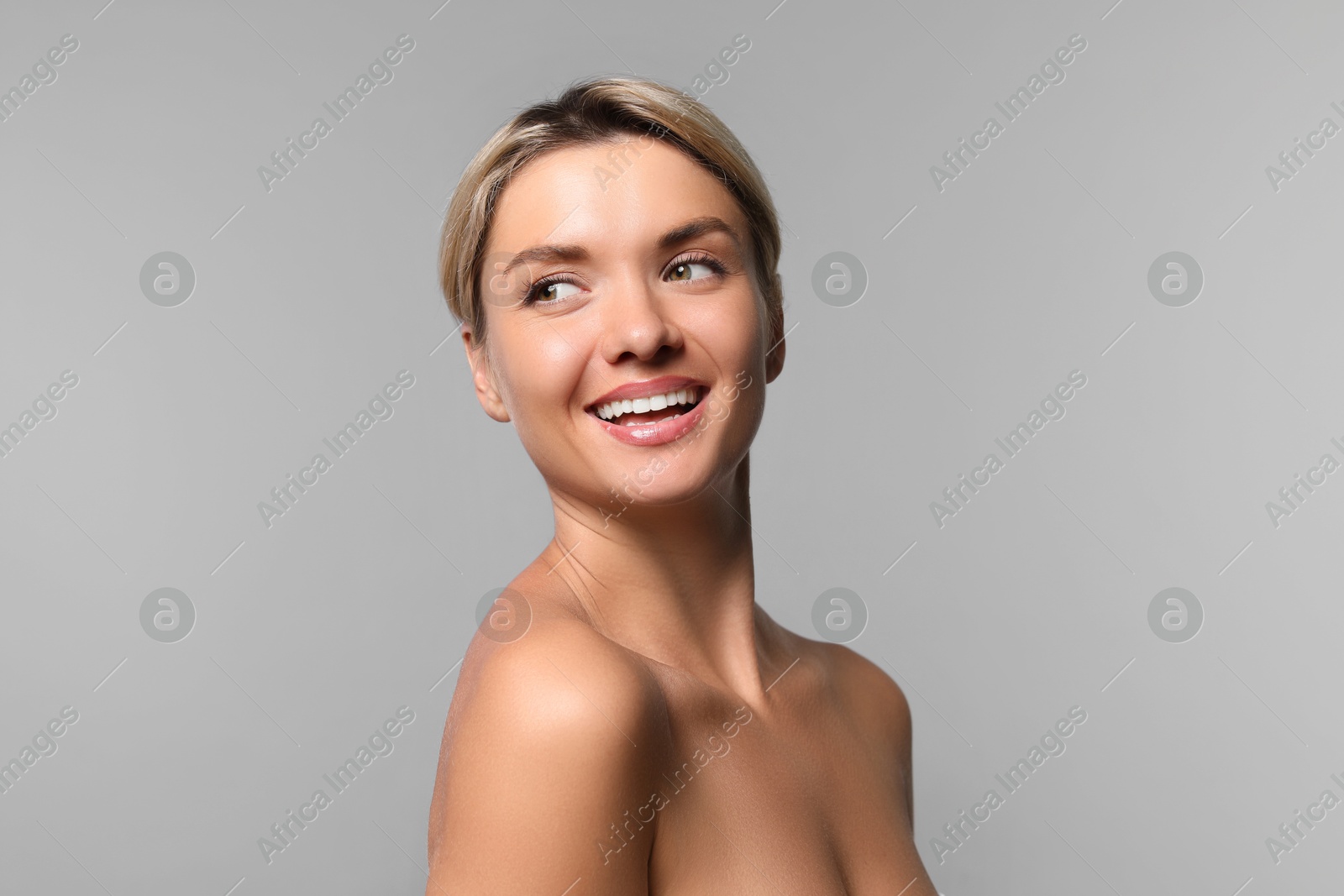 Photo of Cosmetology. Beautiful woman with perfect skin on grey background