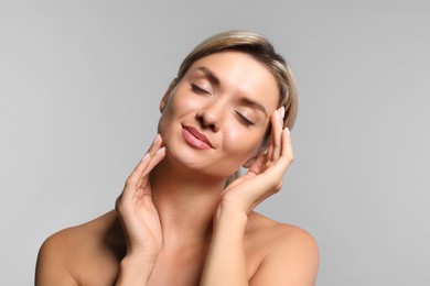 Photo of Cosmetology. Beautiful woman with perfect skin on grey background