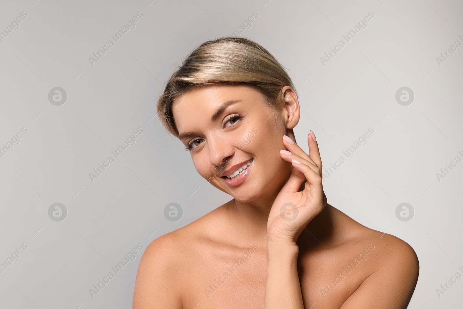 Photo of Cosmetology. Beautiful woman with perfect skin on grey background