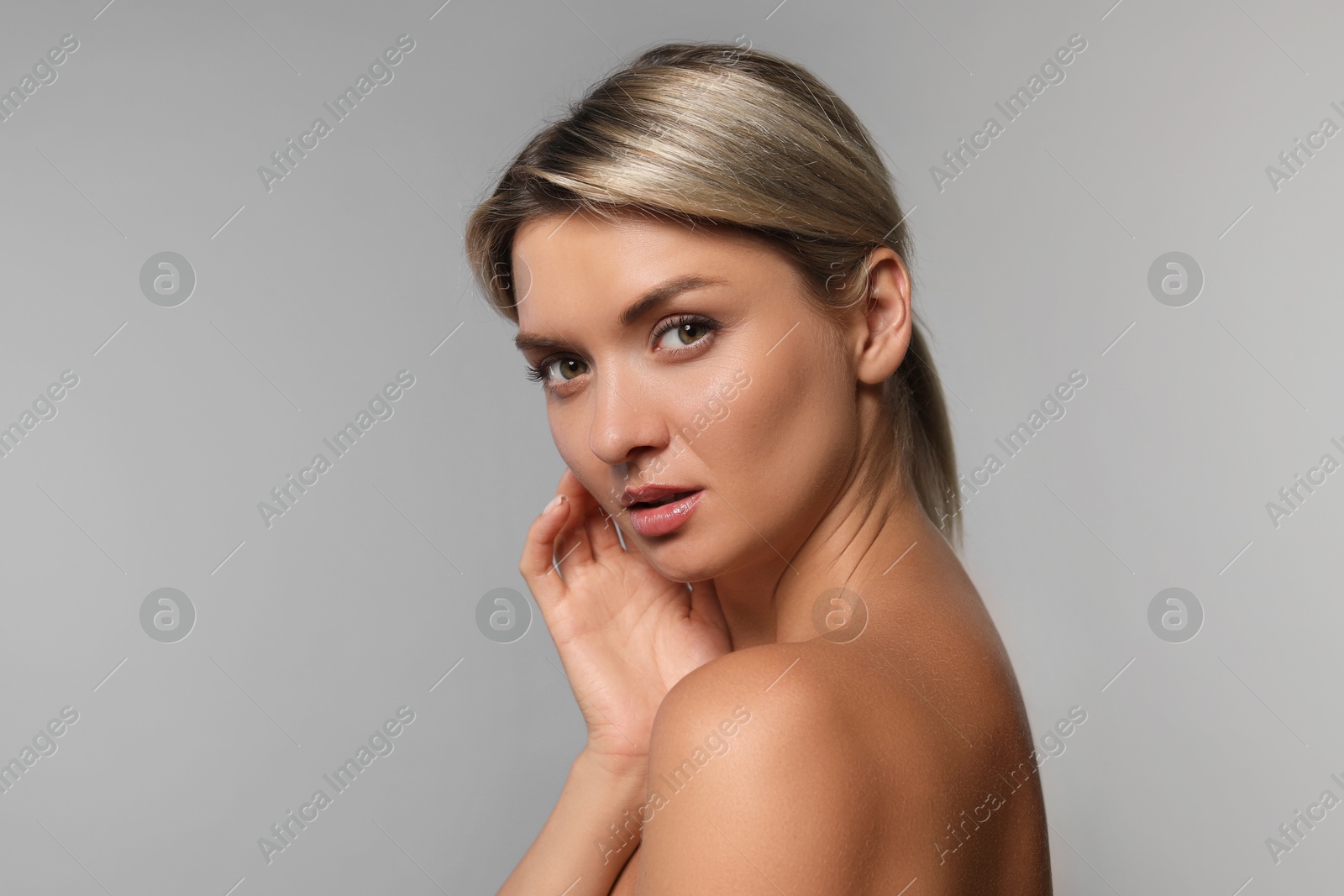 Photo of Cosmetology. Beautiful woman with perfect skin on grey background