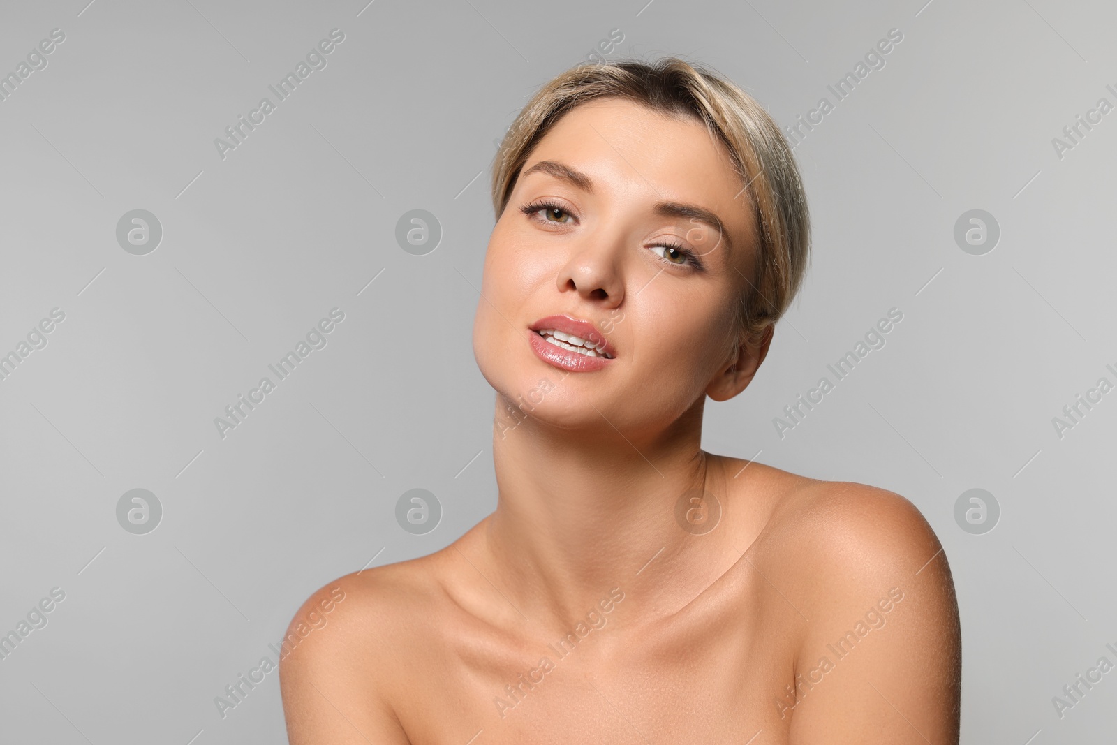 Photo of Cosmetology. Beautiful woman with perfect skin on grey background