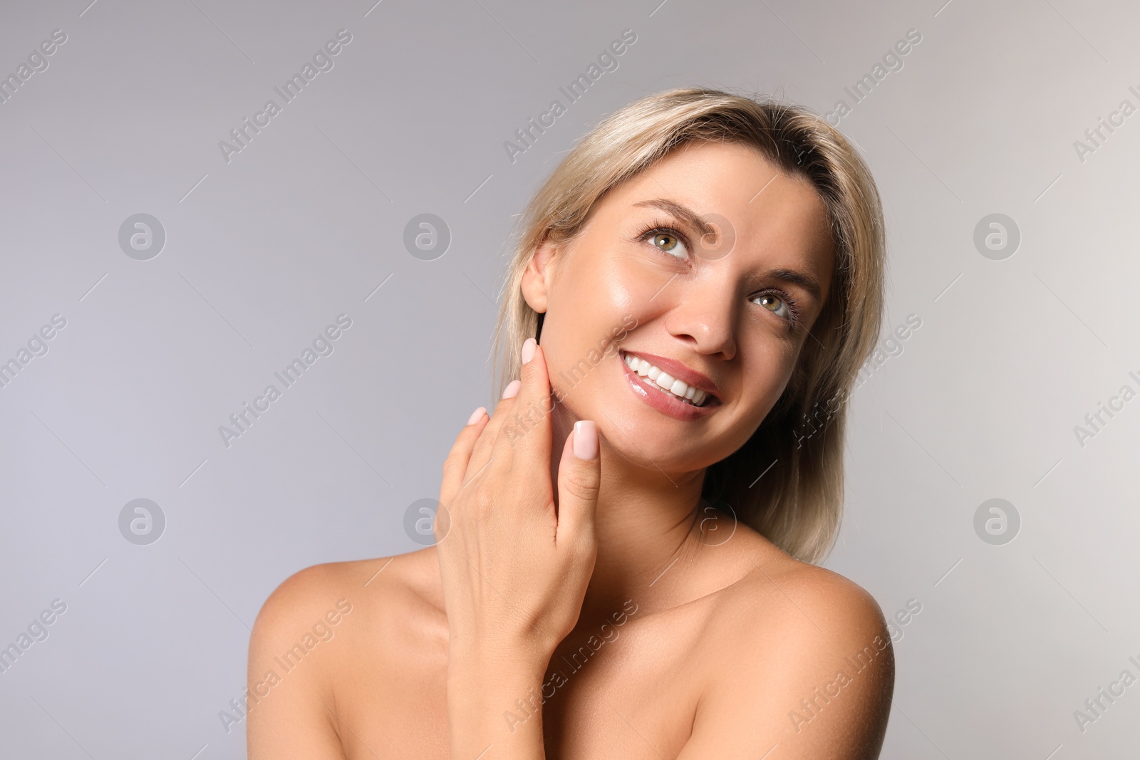 Photo of Cosmetology. Beautiful woman with perfect skin on grey background