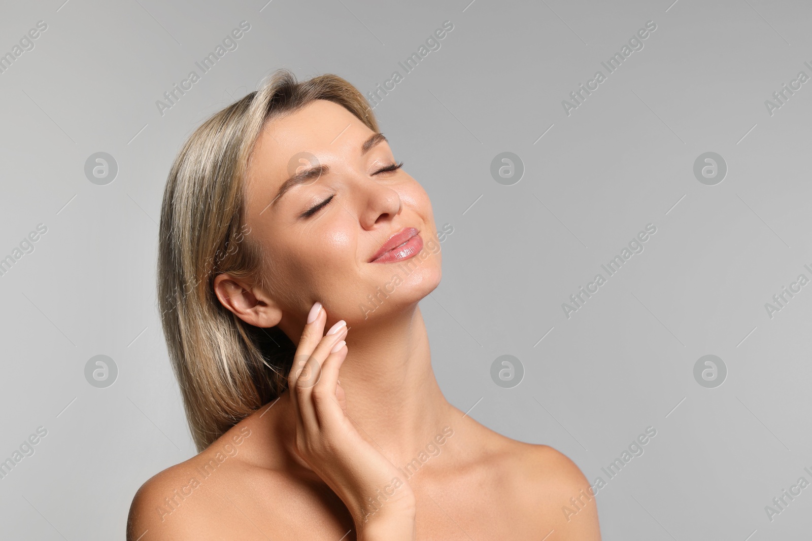 Photo of Cosmetology. Beautiful woman with perfect skin on grey background