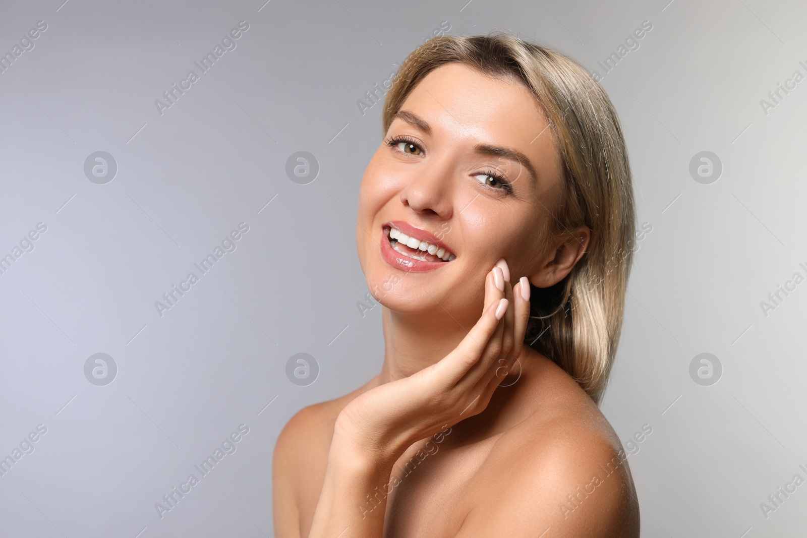 Photo of Cosmetology. Beautiful woman with perfect skin on grey background