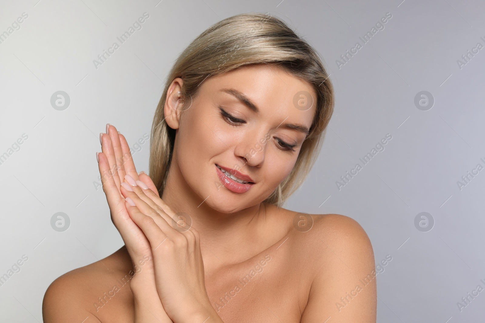 Photo of Cosmetology. Beautiful woman with perfect skin on grey background