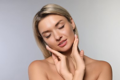 Photo of Cosmetology. Beautiful woman with perfect skin on grey background