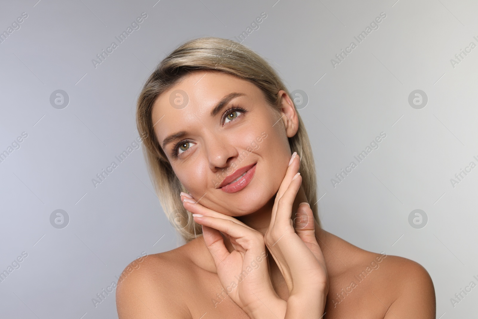 Photo of Cosmetology. Beautiful woman with perfect skin on grey background