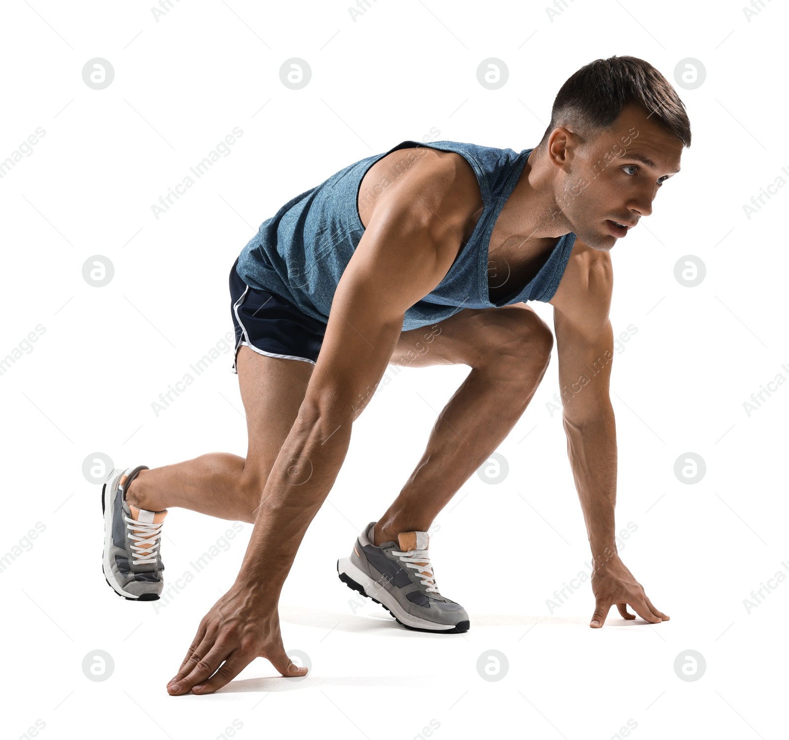 Photo of Sportsman in starting position for run on white background