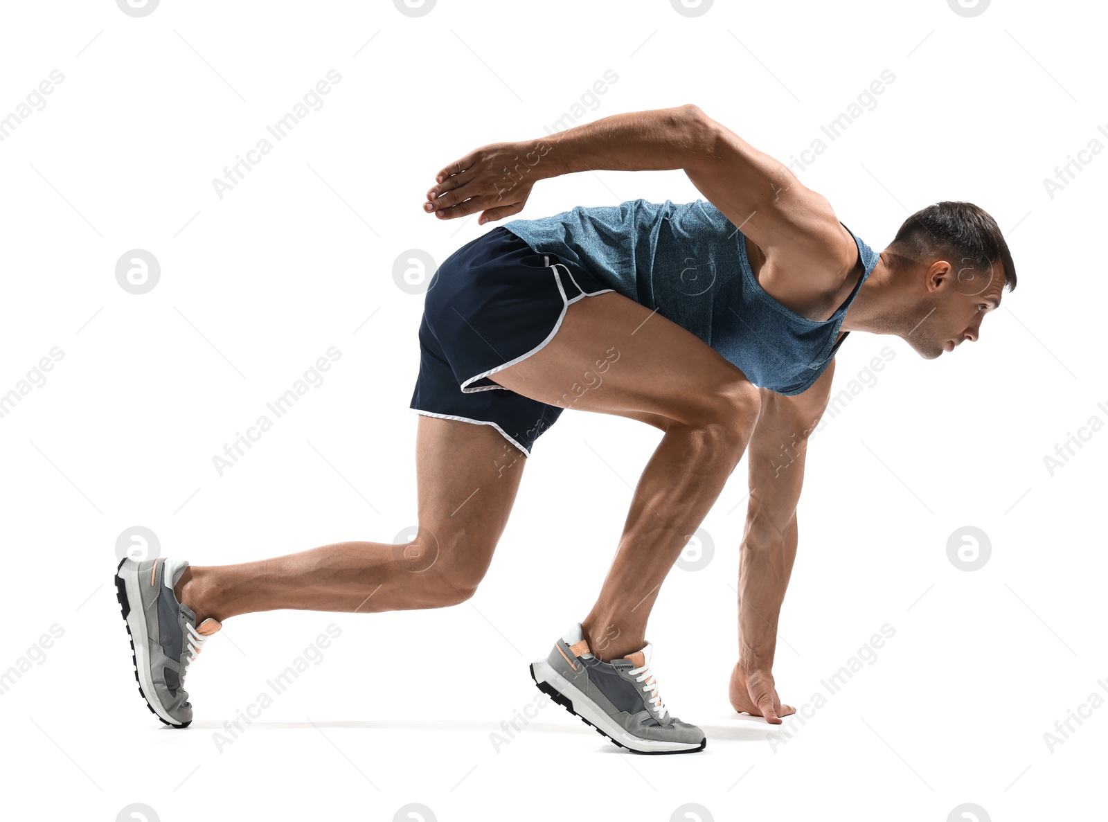 Photo of Sportsman in starting position for run on white background