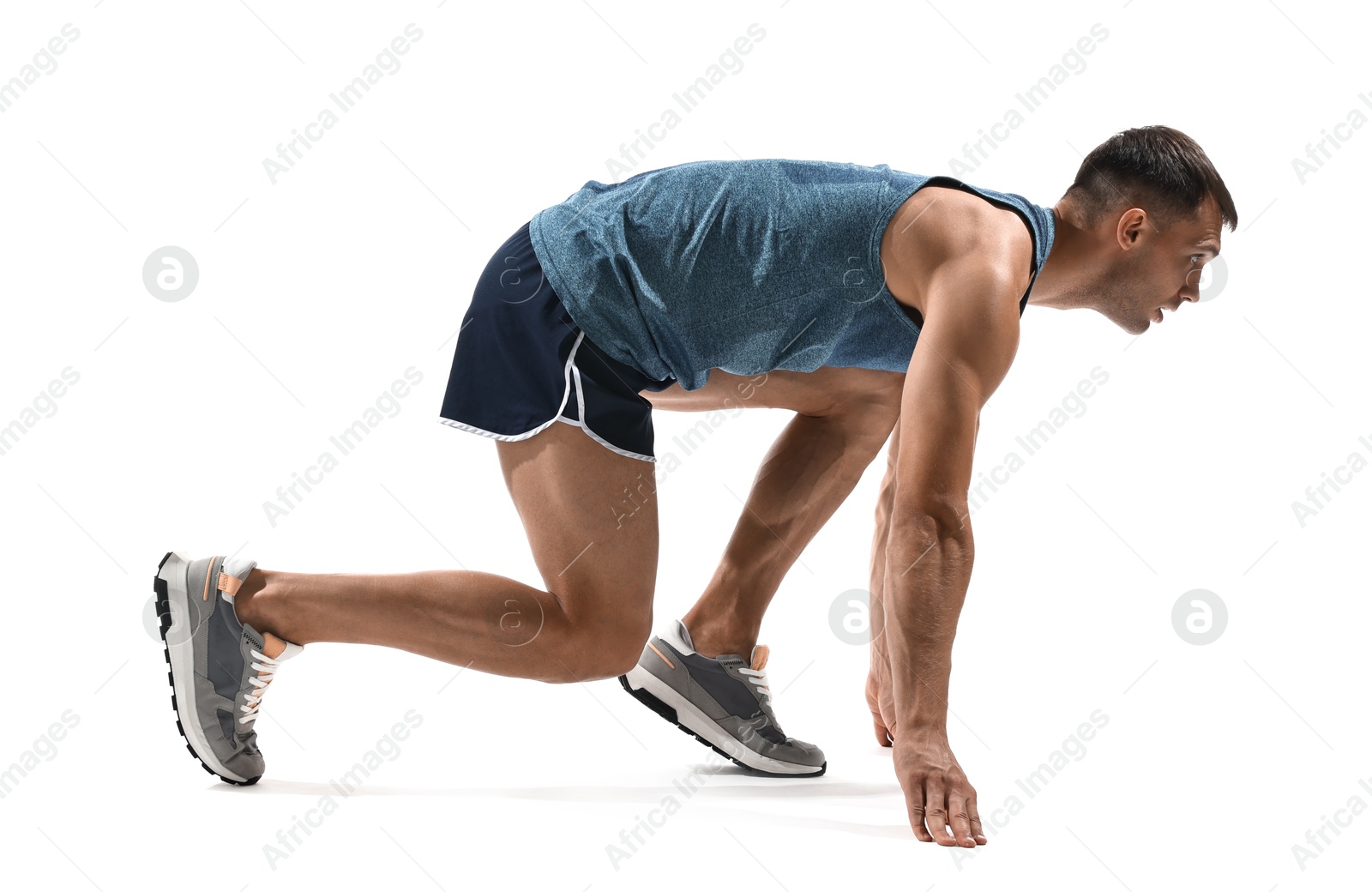 Photo of Sportsman in starting position for run on white background