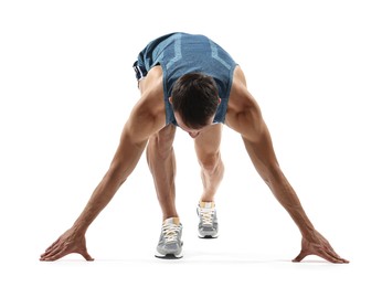 Sportsman in starting position for run on white background