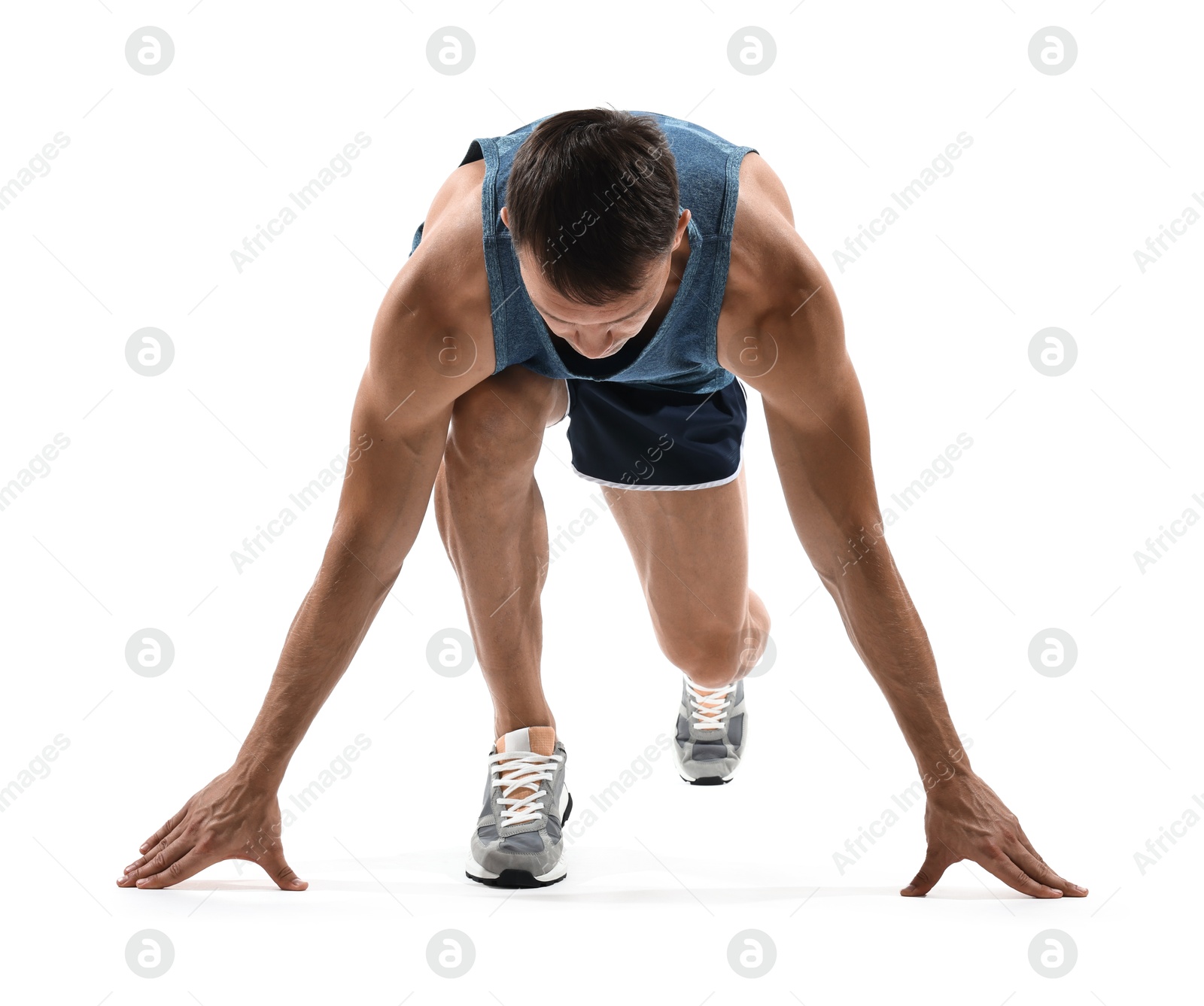 Photo of Sportsman in starting position for run on white background